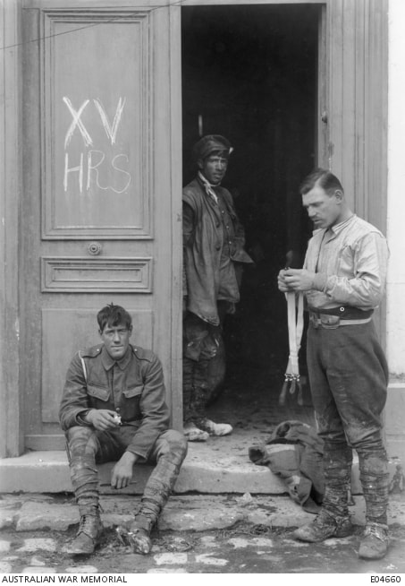Corbie, France. 31 March 1918. Informal portrait of British cavalrymen cleaning up at Corbie after several days' hard fighting. Note the initials XV HRS on the door on the left.
