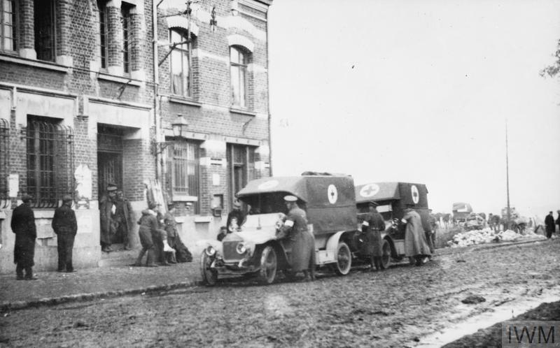 Loading wounded from the Mairie at Erquinghem-Lys to ambulance wagon. March 1915. 18th Field Ambulance, 6th Division. © IWM (Q 50228)