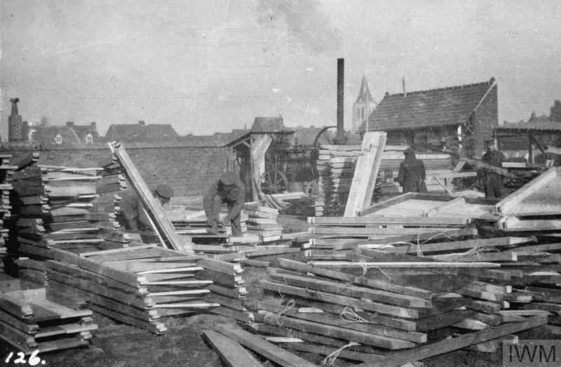Piles of dug-out frames in the Royal Engineers' Yard at Erquinghem, 7th February 1915. (Note the Church spire in the background) © IWM (Q 51574)