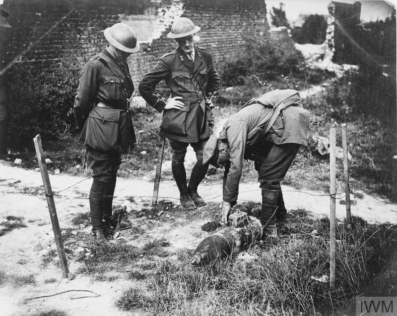 Preparing to explode a German 'dud' shell with a guncotton charge. In front of Zillebeke, 24 September 1917. © IWM (Q 6017)