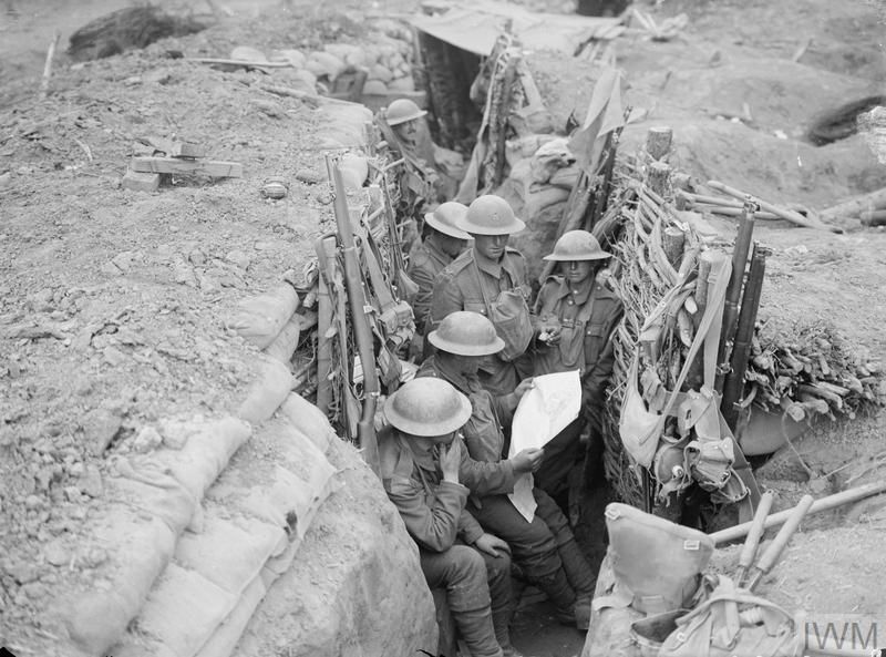 Soldiers, probably from the 12th Battalion, the East Surrey Regiment, seen in a British communication trench in Ploegsteert Wood, during the Battle of Messines, 11th June 1917.